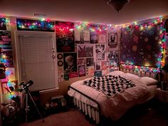 a bed room with a checkered blanket on top of it and lots of lights