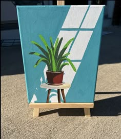 a potted plant sitting on top of a wooden easel