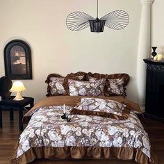 a bed in a bedroom with brown comforter and pillows