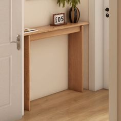 a wooden table with a clock on it next to a white door and some plants