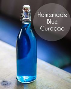 a blue glass bottle sitting on top of a wooden table