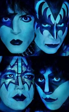 the faces of kiss band members are shown in blue light, with black and white makeup