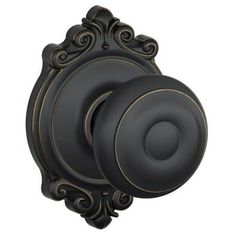 an ornate black door knob with gold accents