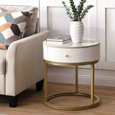 a living room with a chair, table and potted plant on the end table