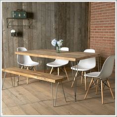 an image of a dining table and chairs in the middle of a wood floored room