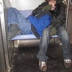 two people sitting on a bus next to each other