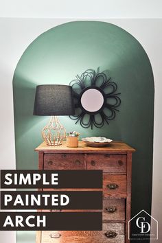 a simple painted arch in the corner of a room with a lamp and dresser on it