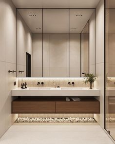 a modern bathroom with two sinks and mirrors