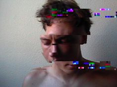 a man with no shirt on is looking at the camera and has multiple colored squares over his face