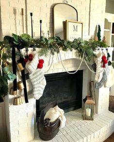 a fireplace decorated for christmas with stockings and stockings hanging from the mantle