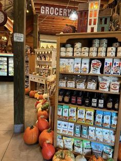 a grocery store filled with lots of pumpkins and other foods on the shelves in front of it