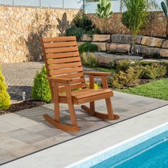 a wooden chair sitting next to a swimming pool