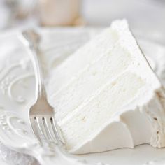 a piece of cake sitting on top of a white plate with a fork in it