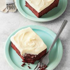 two plates with slices of red velvet cake on them, one has frosting and the other has icing