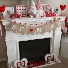 there is a mantle decorated with valentine's day decorations