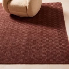 a chair and rug on the floor in a room