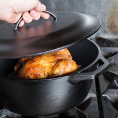 a person is cooking chicken in a pan on the stove