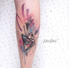 a woman's leg with an all seeing tattoo on it