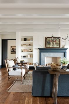 a living room filled with furniture and a fire place