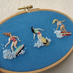 three women on surfboards are depicted in this embroidery pattern