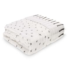 a white blanket with black stars on the top and bottom, folded in two rows