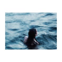 a woman in the water with her back turned to the camera and words written on it