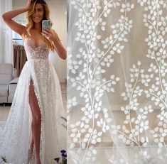 a woman taking a selfie in front of a curtain with white flowers on it