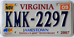 a white license plate with the words, kmk - 2097 in blue and orange