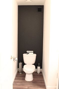 a white toilet sitting inside of a bathroom