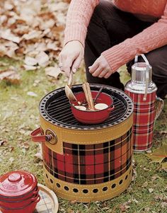 a woman is cooking food on an outdoor grill