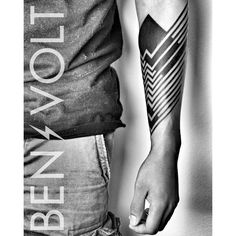 a man's arm with an arrow tattoo on it and the words below him