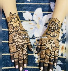 two hands with henna designs on them