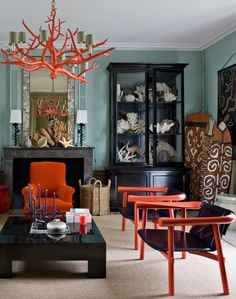 a living room filled with furniture and a chandelier hanging over the top of it