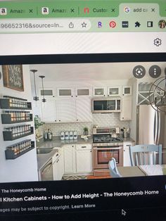 an image of a kitchen with white cabinets and stainless steel appliances on the computer screen