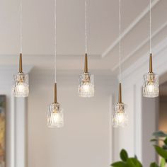 four lights hanging from a ceiling in a living room