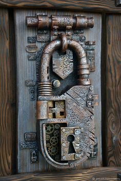 an old wooden door with a lock and key on the front, which is made out of wood