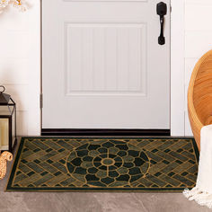 a white door with a black and gold rug next to it