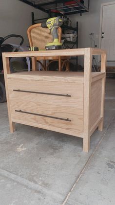 a wooden dresser sitting inside of a garage