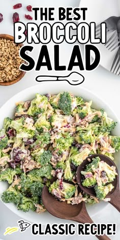 broccoli salad in a white bowl with wooden serving spoons on the side