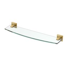 a glass shelf with two brass brackets on it