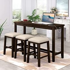 a computer desk with two stools and a laptop on the table in front of it