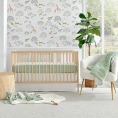 a baby's room with an elephant wallpaper