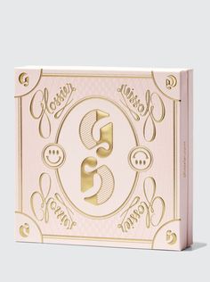 a pink and gold box with the letter s on it