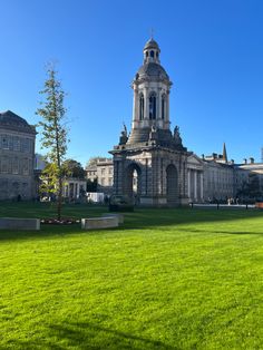 a large building sitting on top of a lush green field