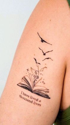 a woman with a book tattoo on her arm and the words i have lived a thousand lives