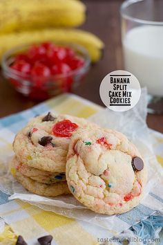 cookies with chocolate chips and cherries on a table