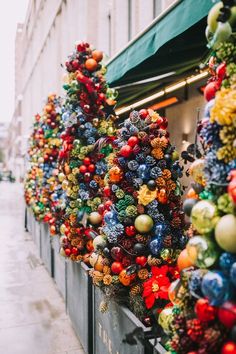 christmas decorations are displayed on the side of a building