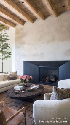 a living room filled with furniture and a fire place in the middle of a room