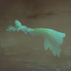 a blurry image of a woman floating in the air