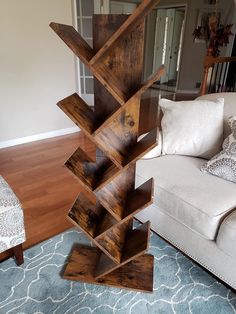 a wooden sculpture sitting in the middle of a living room